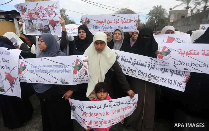 Palestinians hold banners during a protest against froze tens of millions of dollars in contributions to the United Nations Relief and Work Agency (UNRWA), and Israeli blockade on Gaza strip, in front of the headquarter...
