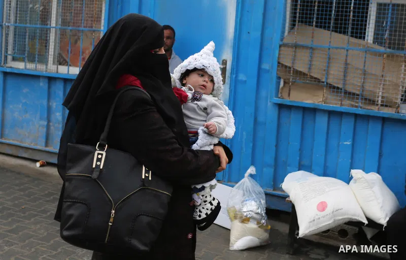 Palestinian refugees collect aid parcels at a United Nations food distribution centre in Khan Yunis in the southern Gaza Strip on January 28, 2018. On January 16, Washington held back $65 million that had been earmarked...