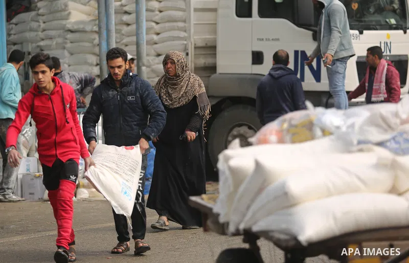 Palestinian refugees collect aid parcels at a United Nations food distribution centre in Khan Yunis in the southern Gaza Strip on January 28, 2018. On January 16, Washington held back $65 million that had been earmarked...