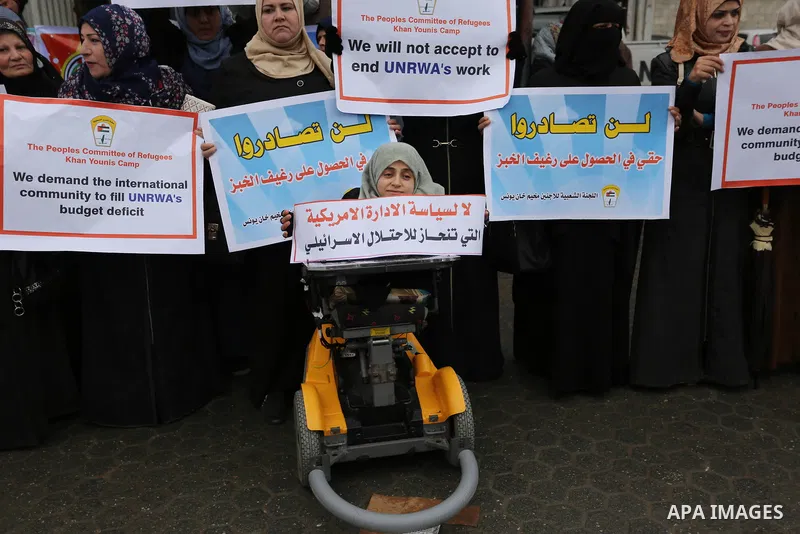Palestinians take part in a protest against aid cuts, outside the United Nations' offices in Khan Yunis in the southern Gaza Strip on January 28, 2018. On January 16, Washington held back $65 million that had been earmar...