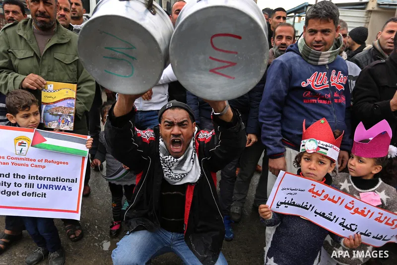 Palestinians take part in a protest against aid cuts, outside the United Nations' offices in Khan Yunis in the southern Gaza Strip on January 28, 2018. On January 16, Washington held back $65 million that had been earmar...