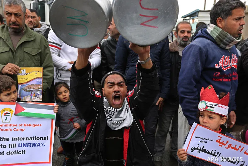 Palestinians take part in a protest against aid cuts, outside the United Nations' offices in Khan Yunis in the southern Gaza Strip on January 28, 2018. On January 16, Washington held back $65 million that had been earmar...