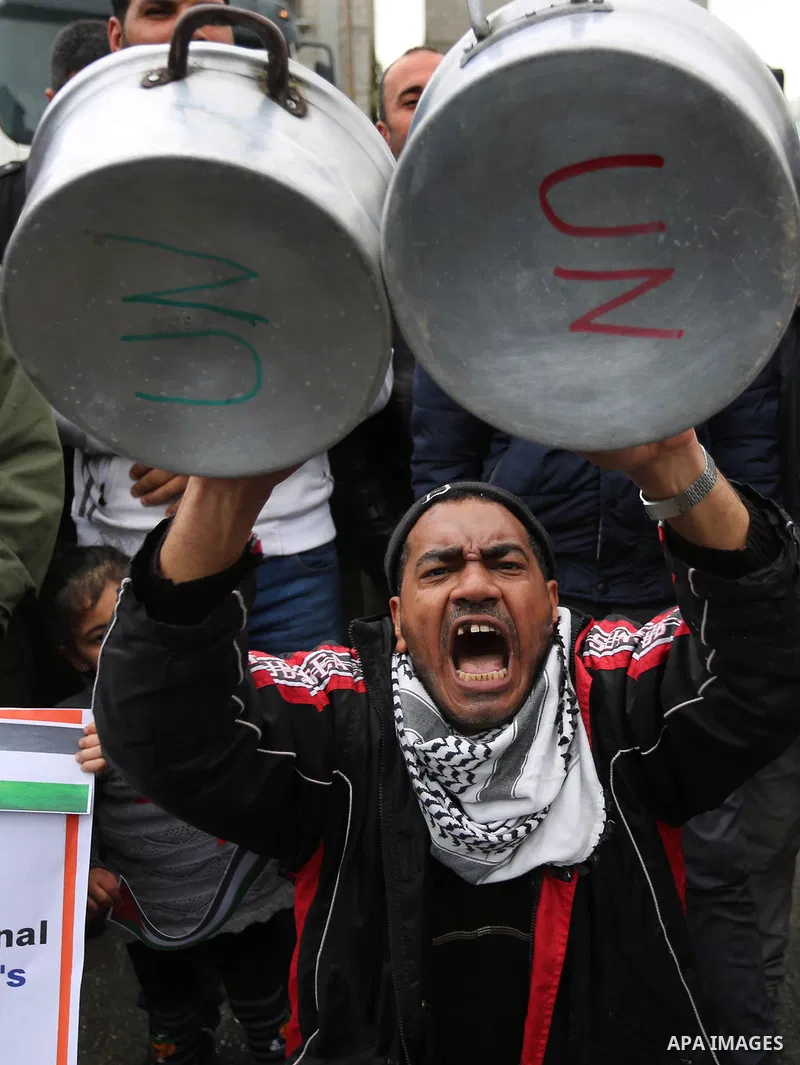 Palestinians take part in a protest against aid cuts, outside the United Nations' offices in Khan Yunis in the southern Gaza Strip on January 28, 2018. On January 16, Washington held back $65 million that had been earmar...