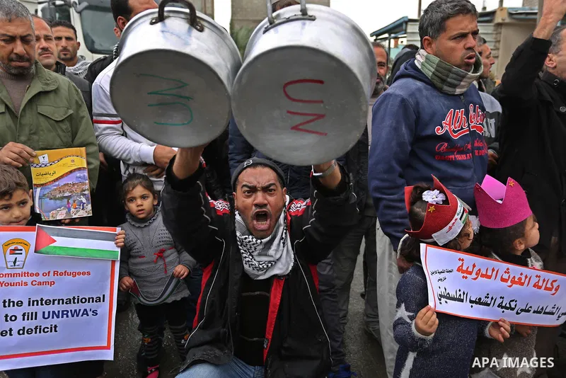 Palestinians take part in a protest against aid cuts, outside the United Nations' offices in Khan Yunis in the southern Gaza Strip on January 28, 2018. On January 16, Washington held back $65 million that had been earmar...