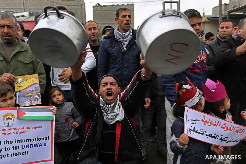 Palestinians take part in a protest against aid cuts, outside the United Nations' offices in Khan Yunis in the southern Gaza Strip on January 28, 2018. On January 16, Washington held back $65 million that had been earmar...