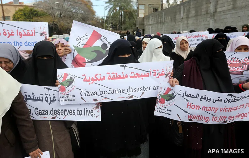 Palestinians hold banners during a protest against froze tens of millions of dollars in contributions to the United Nations Relief and Work Agency (UNRWA), and Israeli blockade on Gaza strip, in front of the headquarter...