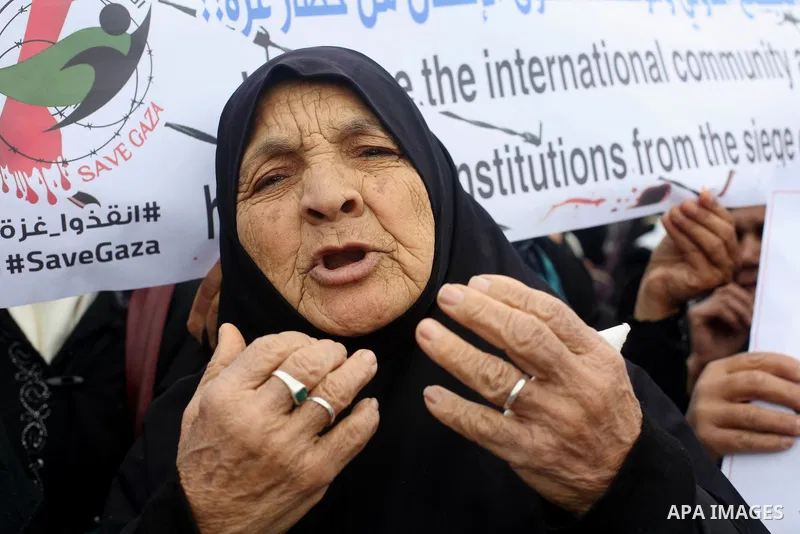 Palestinians hold banners during a protest against froze tens of millions of dollars in contributions to the United Nations Relief and Work Agency (UNRWA), and Israeli blockade on Gaza strip, in front of the headquarter...