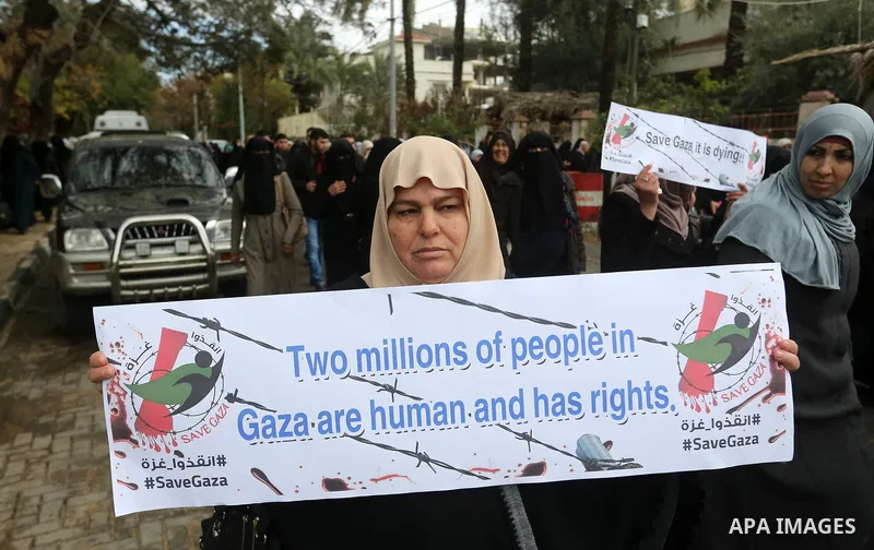 Palestinians hold banners during a protest against froze tens of millions of dollars in contributions to the United Nations Relief and Work Agency (UNRWA), and Israeli blockade on Gaza strip, in front of the headquarter...