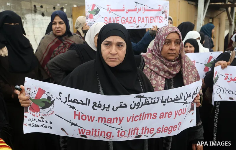Palestinians hold banners during a protest against froze tens of millions of dollars in contributions to the United Nations Relief and Work Agency (UNRWA), and Israeli blockade on Gaza strip, in front of the headquarter...