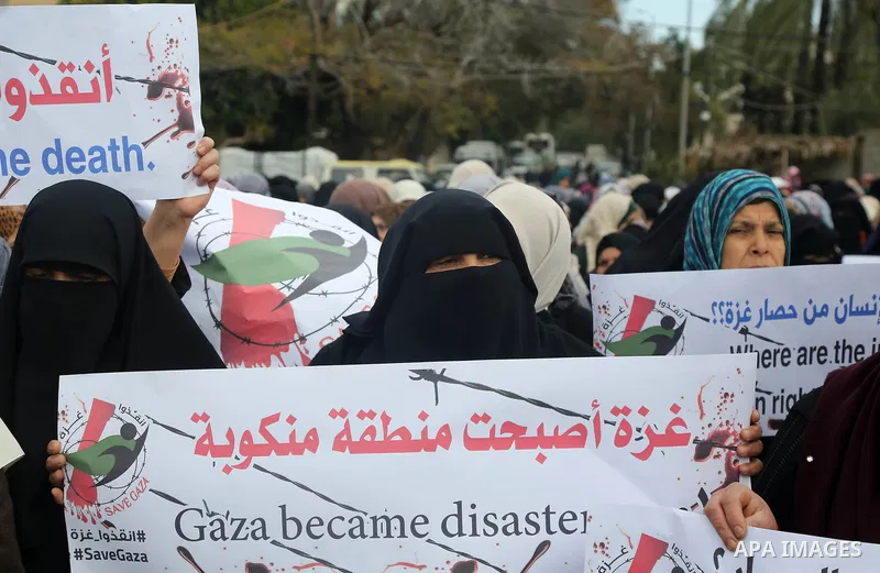 Palestinians hold banners during a protest against froze tens of millions of dollars in contributions to the United Nations Relief and Work Agency (UNRWA), and Israeli blockade on Gaza strip, in front of the headquarter...