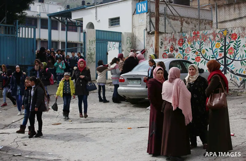 Palestinians take part in a protest against froze tens of millions of dollars in contributions to the United Nations Relief and Work Agency (UNRWA), in the West Bank city of Nablus, on January 28, 2018. Photo by Shadi Ja...