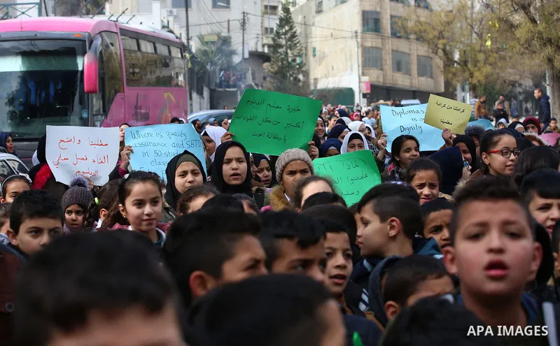 Palestinians take part in a protest against froze tens of millions of dollars in contributions to the United Nations Relief and Work Agency (UNRWA), in the West Bank city of Nablus, on January 28, 2018. Photo by Shadi Ja...