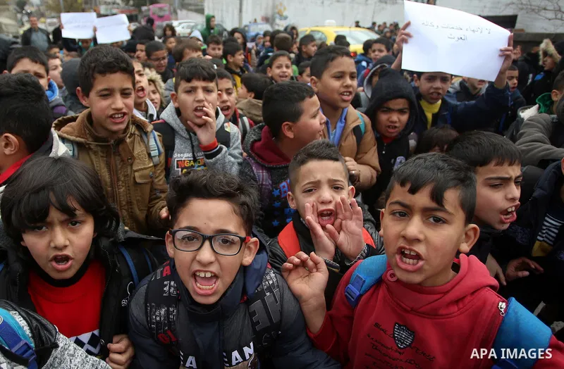 Palestinians take part in a protest against froze tens of millions of dollars in contributions to the United Nations Relief and Work Agency (UNRWA), in the West Bank city of Nablus, on January 28, 2018. Photo by Shadi Ja...