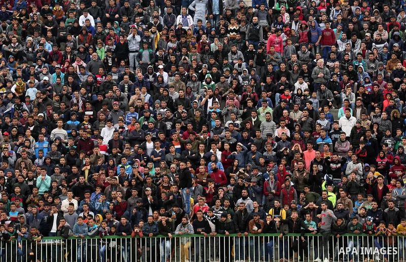 Palestinian fans watch the football match between Al-Nuseirat and Al-Jalaa standing at a stadium, at Nuseirat refugee camp, in the central of Gaza Strip, on January 28, 2018. Palestinian police allowed women to attending...
