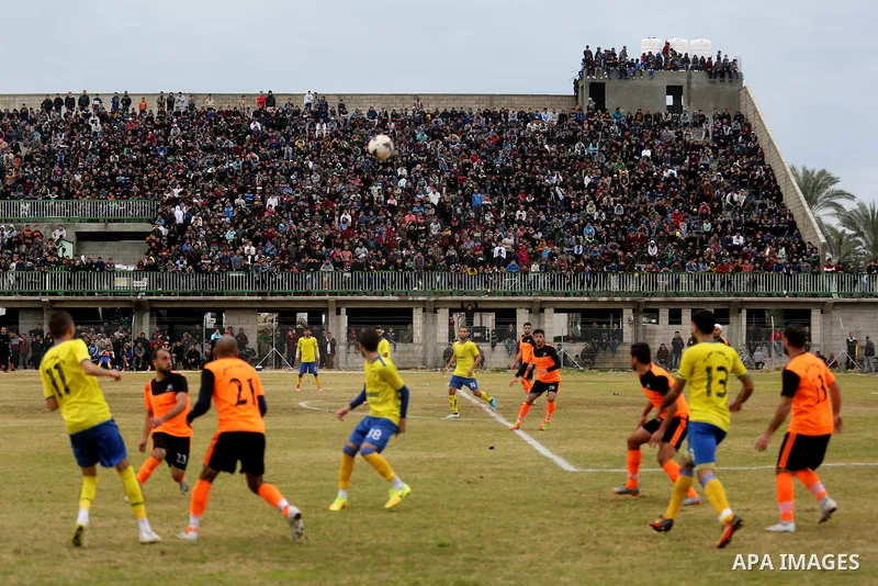 Palestinian player from Al-Nuseirat club and Al-Jalaa club compete during a football match at a stadium at Nuseirat refugee camp, in the central of Gaza Strip, on January 28, 2018. Palestinian police allowed women to att...