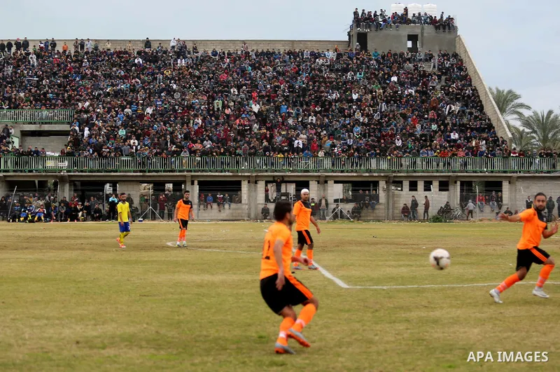 Palestinian player from Al-Nuseirat club and Al-Jalaa club compete during a football match at a stadium at Nuseirat refugee camp, in the central of Gaza Strip, on January 28, 2018. Palestinian police allowed women to att...