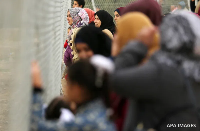 Palestinian women watch the football match between Al-Nuseirat and Al-Jalaa standing outside the fence of the stadium, at Nuseirat refugee camp, in the central of Gaza Strip, on January 28, 2018. Palestinian police allow...