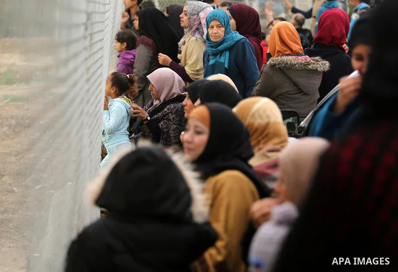 Palestinian women watch the football match between Al-Nuseirat and Al-Jalaa standing outside the fence of the stadium, at Nuseirat refugee camp, in the central of Gaza Strip, on January 28, 2018. Palestinian police allow...