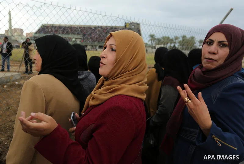 Palestinian women watch the football match between Al-Nuseirat and Al-Jalaa standing outside the fence of the stadium, at Nuseirat refugee camp, in the central of Gaza Strip, on January 28, 2018. Palestinian police allow...