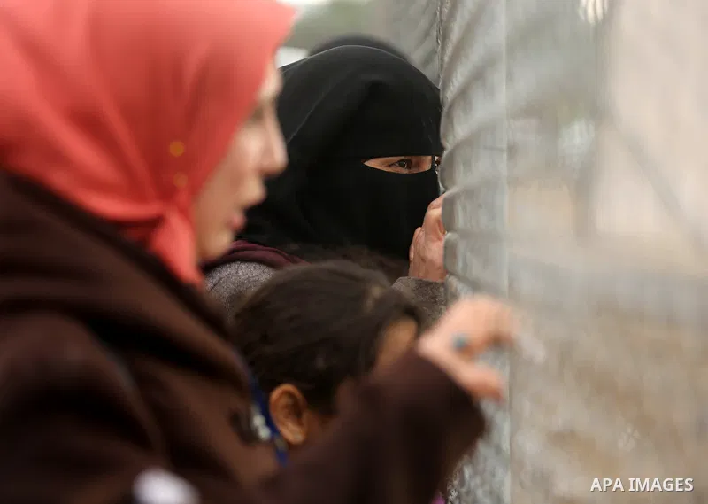 Palestinian women watch the football match between Al-Nuseirat and Al-Jalaa standing outside the fence of the stadium, at Nuseirat refugee camp, in the central of Gaza Strip, on January 28, 2018. Palestinian police allow...