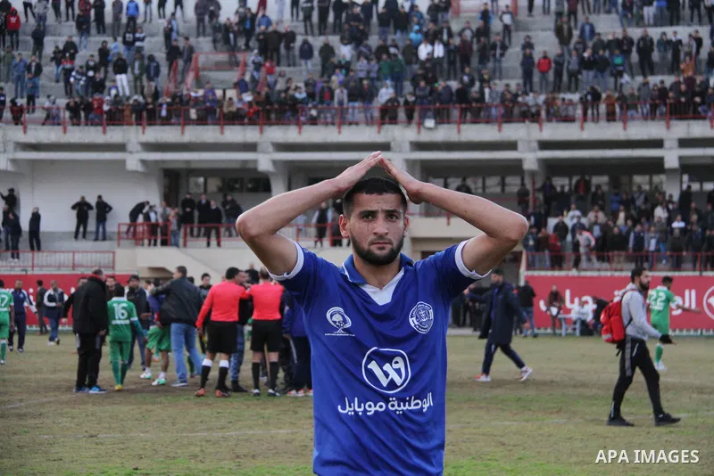 A Palestinian player from Khadamat al-Shati club reacts during a football match with Khadamat Rafah club at Palestine Stadium in Gaza city on January 28, 2018. Photo by Mahmoud Ajour