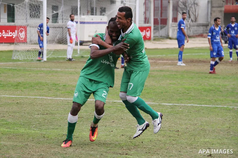 Palestinian players of Khadamat Rafah club celebrate after scoring during their football match with players of Khadamat al-Shati club at Palestine Stadium in Gaza city on January 28, 2018. Photo by Mahmoud Ajour