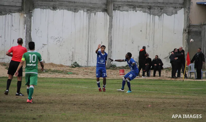 Palestinian players of Khadamat al-Shati club celebrate after scoring during their football match with players of Khadamat Rafah club at Palestine Stadium in Gaza city on January 28, 2018. Photo by Mahmoud Ajour