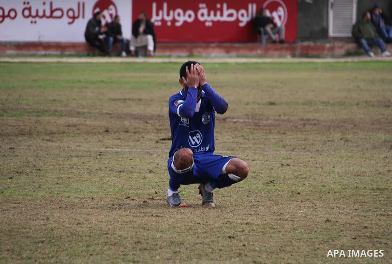 A Palestinian player from Khadamat al-Shati club reacts during a football match with Khadamat Rafah club at Palestine Stadium in Gaza city on January 28, 2018. Photo by Mahmoud Ajour
