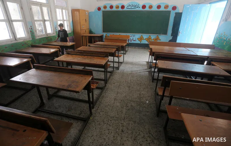 A Palestinian boy stands inside a closed school during the strike against froze tens of millions of dollars in contributions to the United Nations Relief and Work Agency (UNRWA), in Gaza city on January 29, 2018. Photo b...
