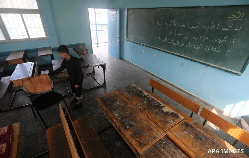 A Palestinian boy stands inside a closed school during the strike against froze tens of millions of dollars in contributions to the United Nations Relief and Work Agency (UNRWA), in Gaza city on January 29, 2018. Photo b...