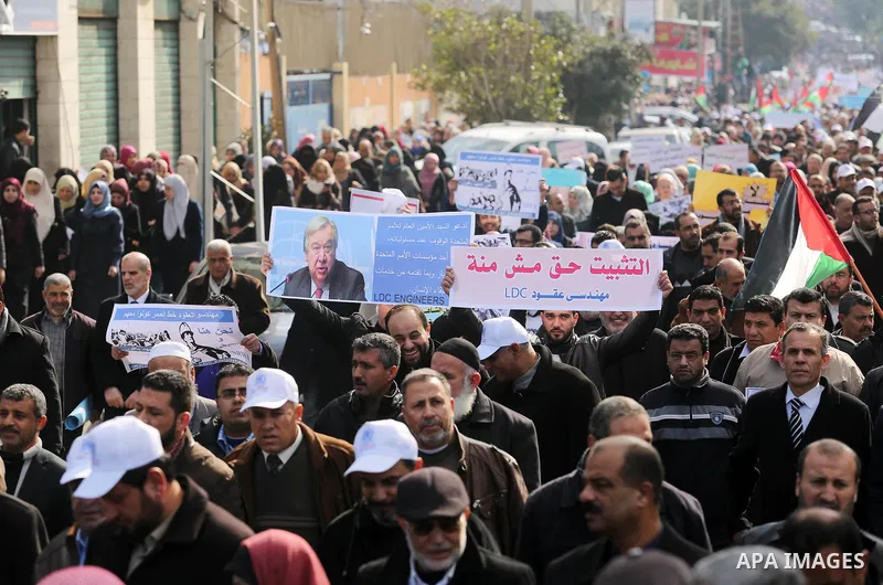 Palestinian employee of United Nations Relief and Works Agency (UNRWA) hold a sign during a protest against a U.S. decision to cut aid, in Gaza City January 29, 2018. Photo by Ashraf Amra