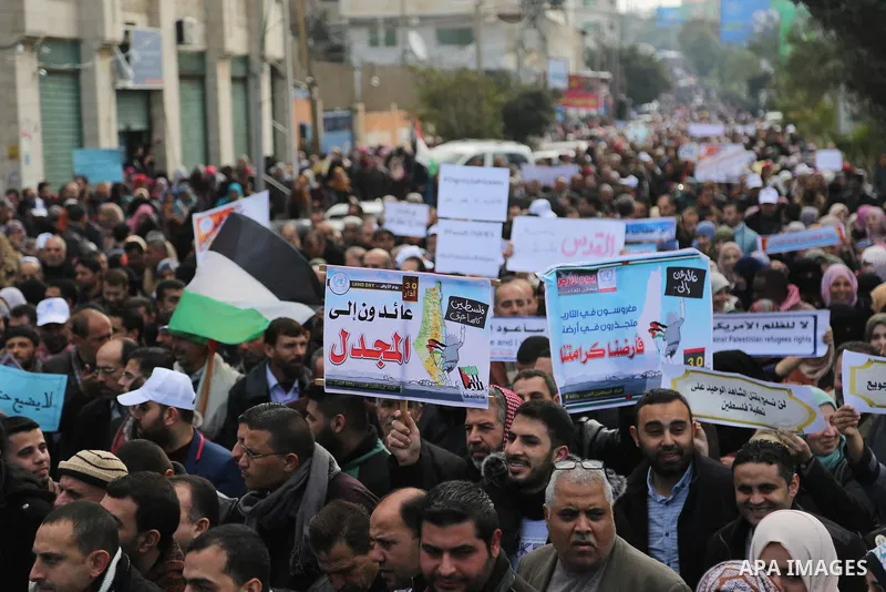Palestinian employee of United Nations Relief and Works Agency (UNRWA) hold a sign during a protest against a U.S. decision to cut aid, in Gaza City January 29, 2018. Photo by Ashraf Amra