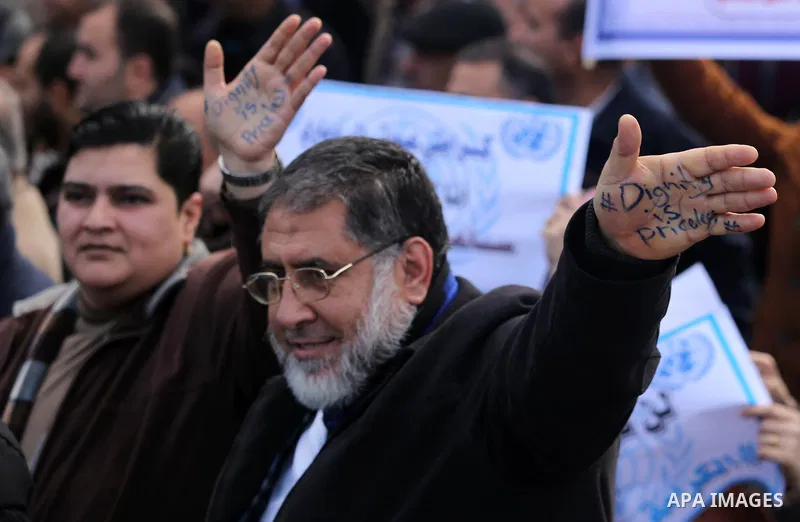 Palestinian employee of United Nations Relief and Works Agency (UNRWA) hold a sign during a protest against a U.S. decision to cut aid, in Gaza City January 29, 2018. Photo by Ashraf Amra