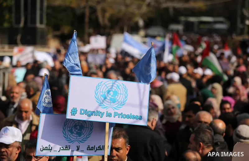 Palestinian employee of United Nations Relief and Works Agency (UNRWA) hold a sign during a protest against a U.S. decision to cut aid, in Gaza City January 29, 2018. Photo by Ashraf Amra