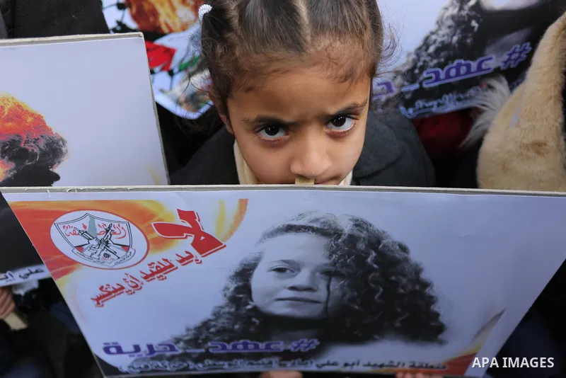 Palestinian children hold poster of teenager Ahed Tamimi, 16-year-old who held in Israeli jails during a protest to show solidarity with her, in front of Red cross office, in Gaza City January 29, 2018. Photo by Ashraf A...