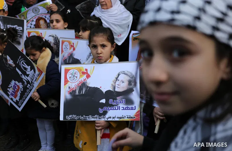 Palestinian children hold poster of teenager Ahed Tamimi, 16-year-old who held in Israeli jails during a protest to show solidarity with her, in front of Red cross office, in Gaza City January 29, 2018. Photo by Ashraf A...