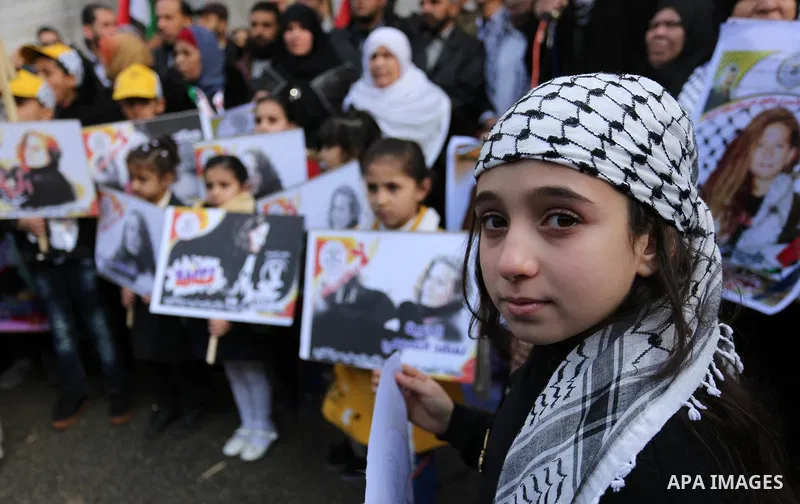 Palestinian children hold poster of teenager Ahed Tamimi, 16-year-old who held in Israeli jails during a protest to show solidarity with her, in front of Red cross office, in Gaza City January 29, 2018. Photo by Ashraf A...