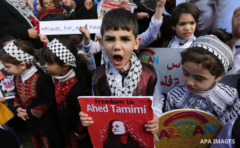 Palestinian children hold poster of teenager Ahed Tamimi, 16-year-old who held in Israeli jails during a protest to show solidarity with her, in front of Red cross office, in Gaza City January 29, 2018. Photo by Ashraf A...