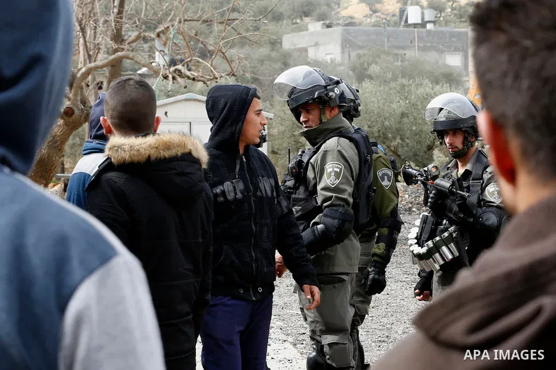 Israeli border police officers stand guard as Israeli machineries demolish an under-construction Palestinian residential building in the West Bank town of Biet Jala, near Bethlehem January 29, 2018. Photo by Wisam Hashla...
