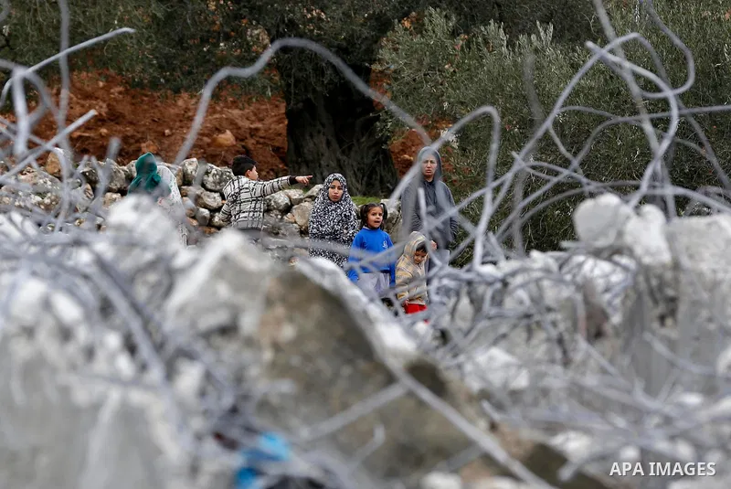 Palestinians stand next to the rubble of two under-construction Palestinian residential buildings after they were demolished by Israeli bulldozers in the West Bank town of Biet Jala, near Bethlehem January 29, 2018. Phot...