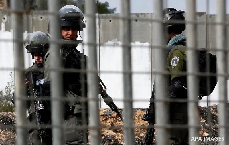 Israeli border police officers stand guard as Israeli machineries demolish an under-construction Palestinian residential building in the West Bank town of Biet Jala, near Bethlehem January 29, 2018. Photo by Wisam Hashla...