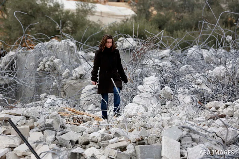 A Palestinian girl walks on the rubble of two under-construction Palestinian residential buildings after they were demolished by Israeli bulldozers in the West Bank town of Biet Jala, near Bethlehem January 29, 2018. Pho...