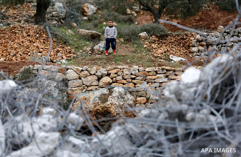 A Palestinian boy stands next to the rubble of two under-construction Palestinian residential buildings after they were demolished by Israeli bulldozers in the West Bank town of Biet Jala, near Bethlehem January 29, 2018...