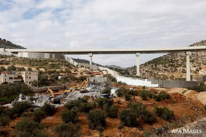 Israeli machineries demolish two under-construction Palestinian residential buildings in the West Bank town of Biet Jala, near Bethlehem January 29, 2018. Photo by Wisam Hashlamoun