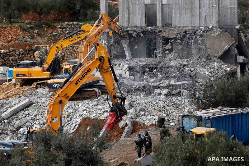 Israeli machineries demolish two under-construction Palestinian residential buildings in the West Bank town of Biet Jala, near Bethlehem January 29, 2018. Photo by Wisam Hashlamoun
