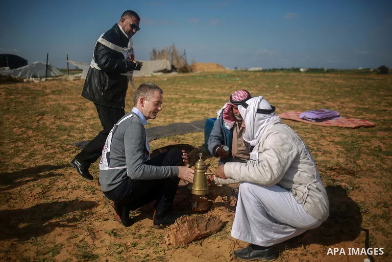 Guislain Defurne, Head of the International Committee of the Red Cross (ICRC) sub-delegation in Gaza drinks coffee during a tour by the International Committee of the Red Cross (ICRC), near the border with Israel, in Raf...