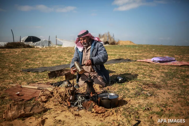 A Palestinian farmer, who his farm near the Israeli border, prepares coffee during a tour by the International Committee of the Red Cross (ICRC), near the border with Israel, in Rafah in the southern Gaza Strip January 2...