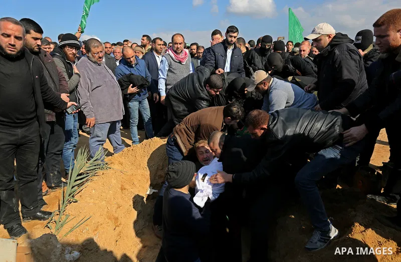 Palestinians bury the body Hamas senior leader Imad al-Alami at a cemetery in Gaza City on January 30, 2018. A senior Hamas official has died in Gaza three weeks after shooting himself in the head in what officials descr...