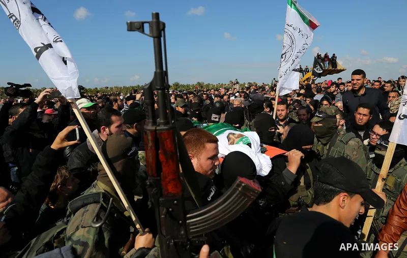 Palestinian militants from the Ezzedine al-Qassam Brigades, the armed wing of the Hamas movement carry the body of Hamas senior leader Imad al-Alami during his funeral in Gaza City on January 30, 2018. A senior Hamas off...