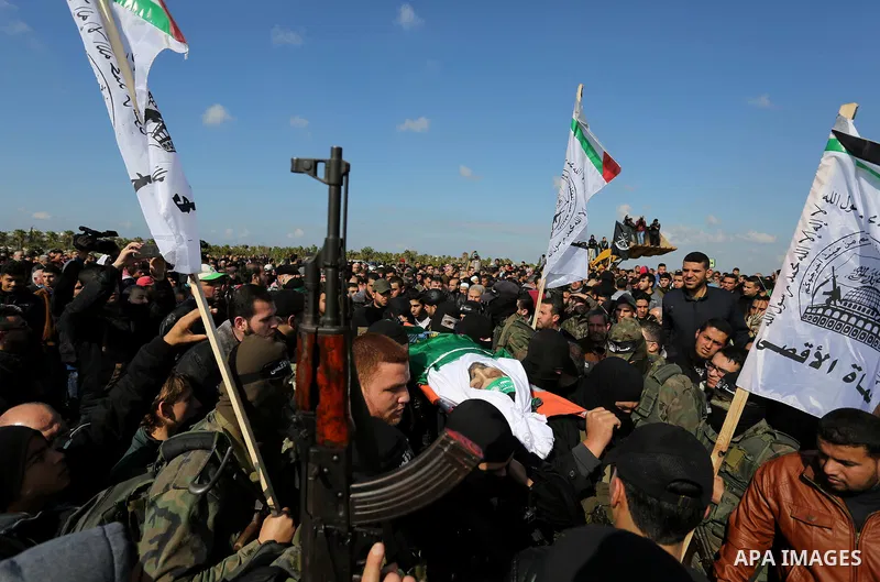 Palestinian militants from the Ezzedine al-Qassam Brigades, the armed wing of the Hamas movement carry the body of Hamas senior leader Imad al-Alami during his funeral in Gaza City on January 30, 2018. A senior Hamas off...